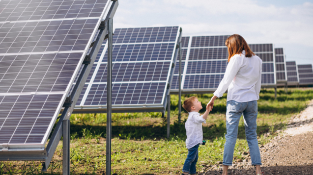 Mother with her little son by solar panels